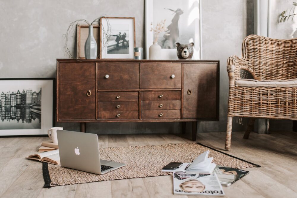 living room floor with books and laptop